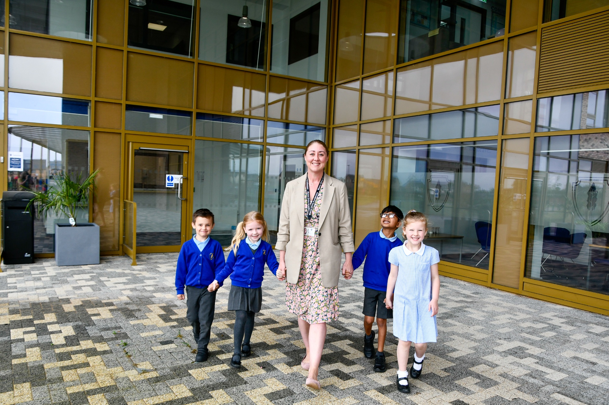 A photo of the Headteacher walking with 4 pupils