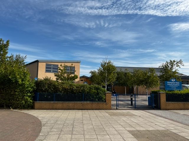 A picture of the front of the school from outside the school gates