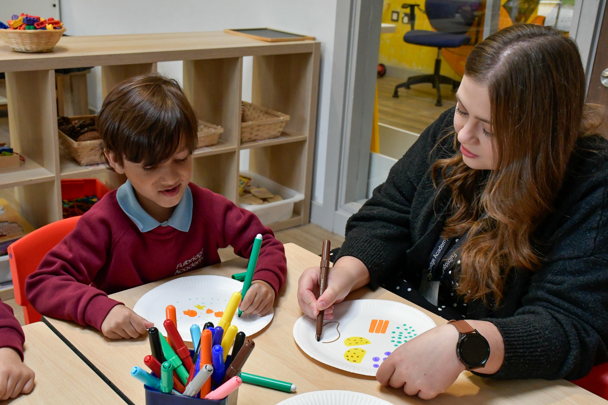 A photo of a student working with a member of staff