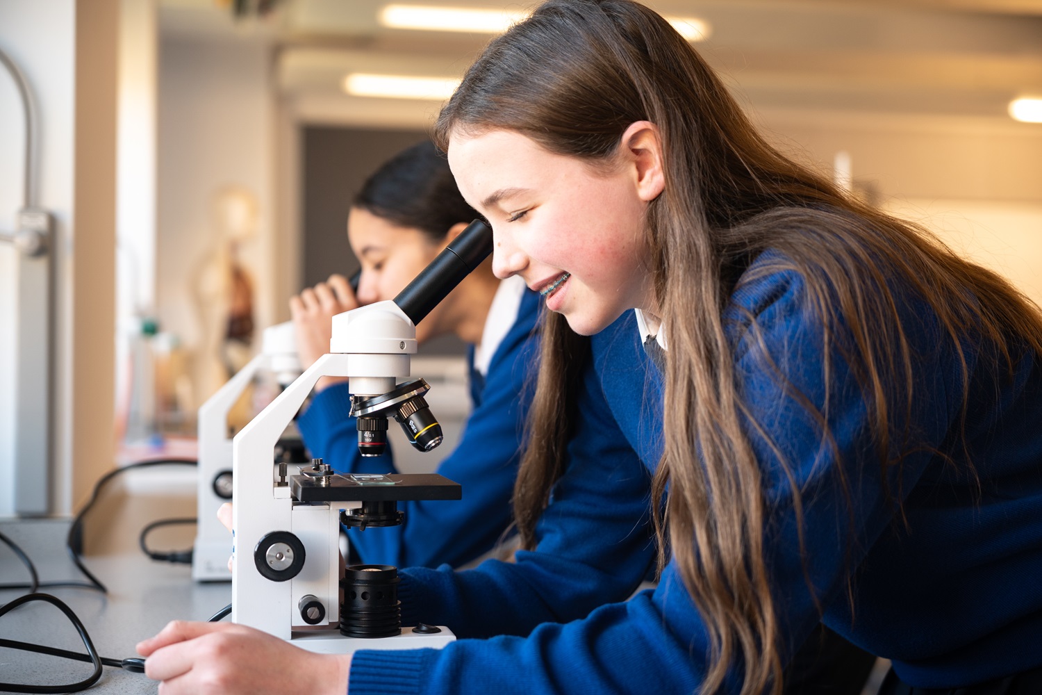 A photo of students looking through microscopes